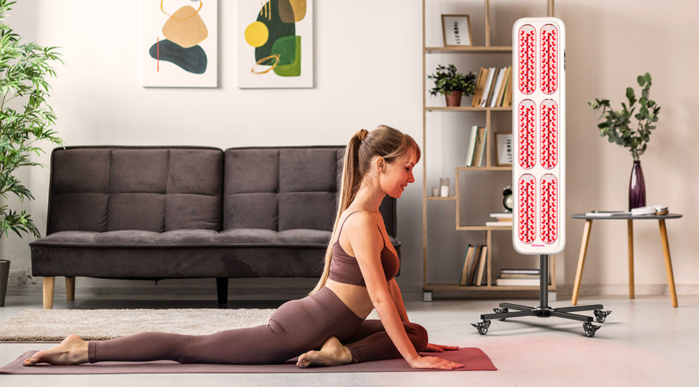 a woman exercise and using red light therapy lighting fixture at home